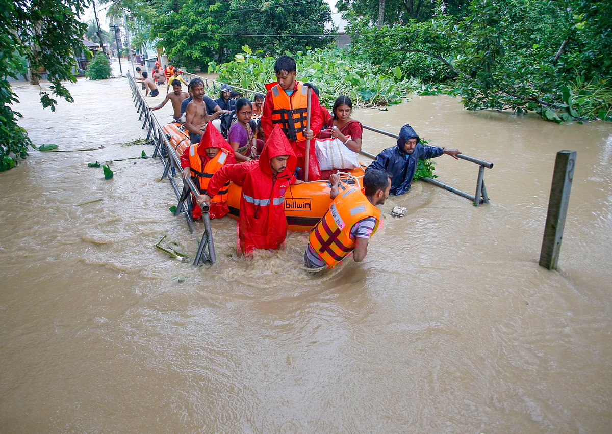 PTI : NDRF personnel evacuate people from a flood-affected area following heavy monsoon rainfall, at Adhaynagar village, on the outskirts of Agartala